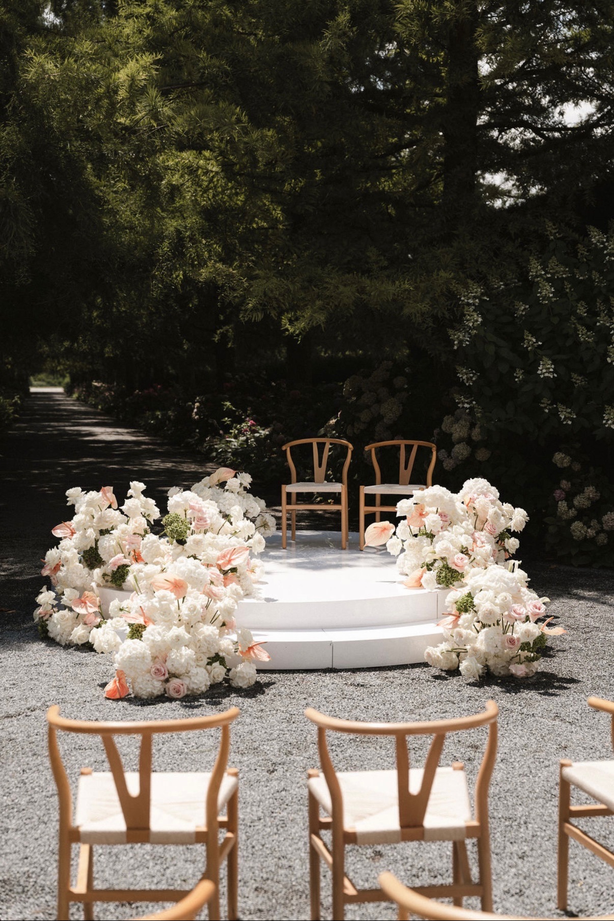 Freie Trauung mit Blumenbogen und Holzstühlen